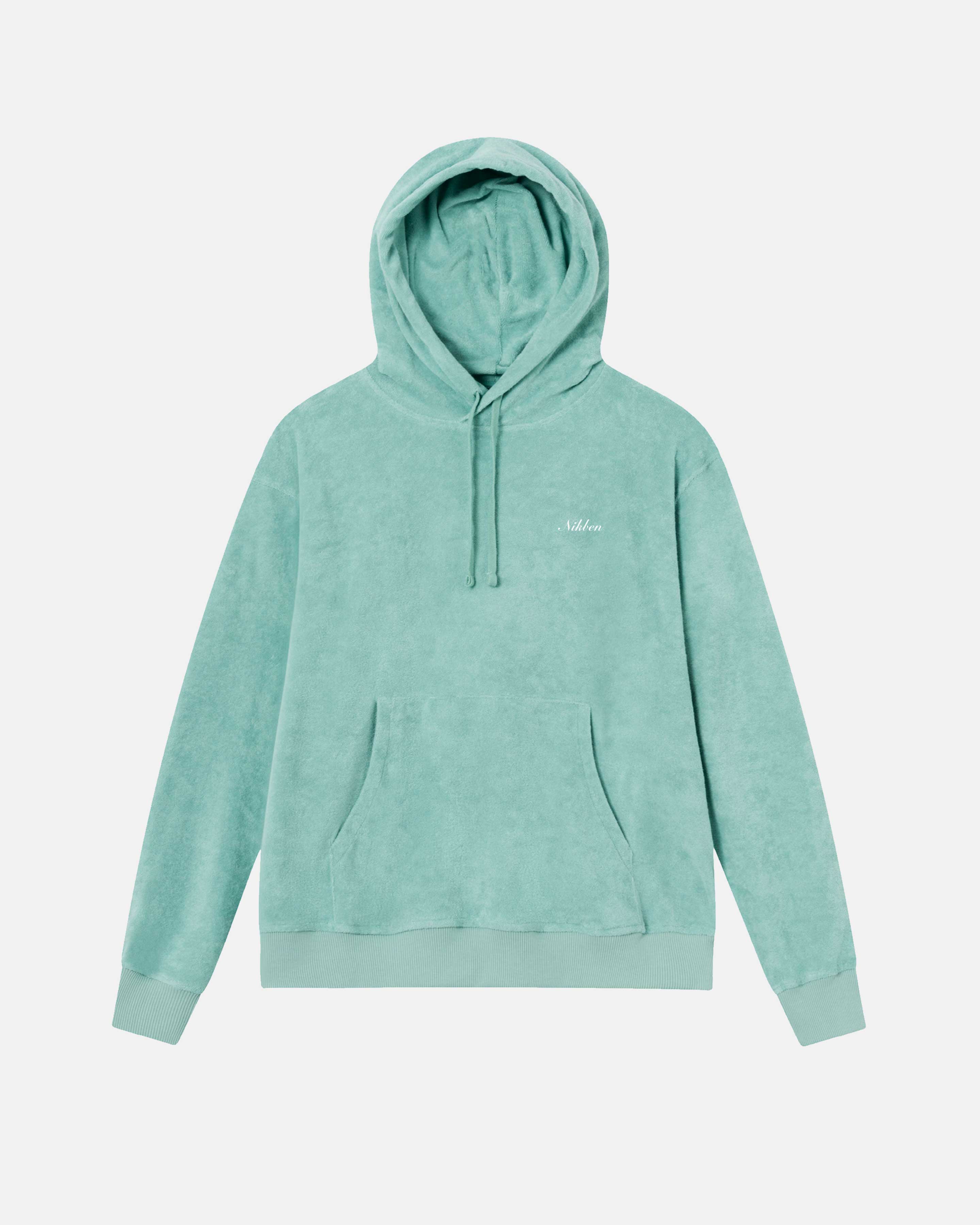 Green hoodie made from terry toweling cloth. It features drawstrings, a single front pocket, and a white embroidered 