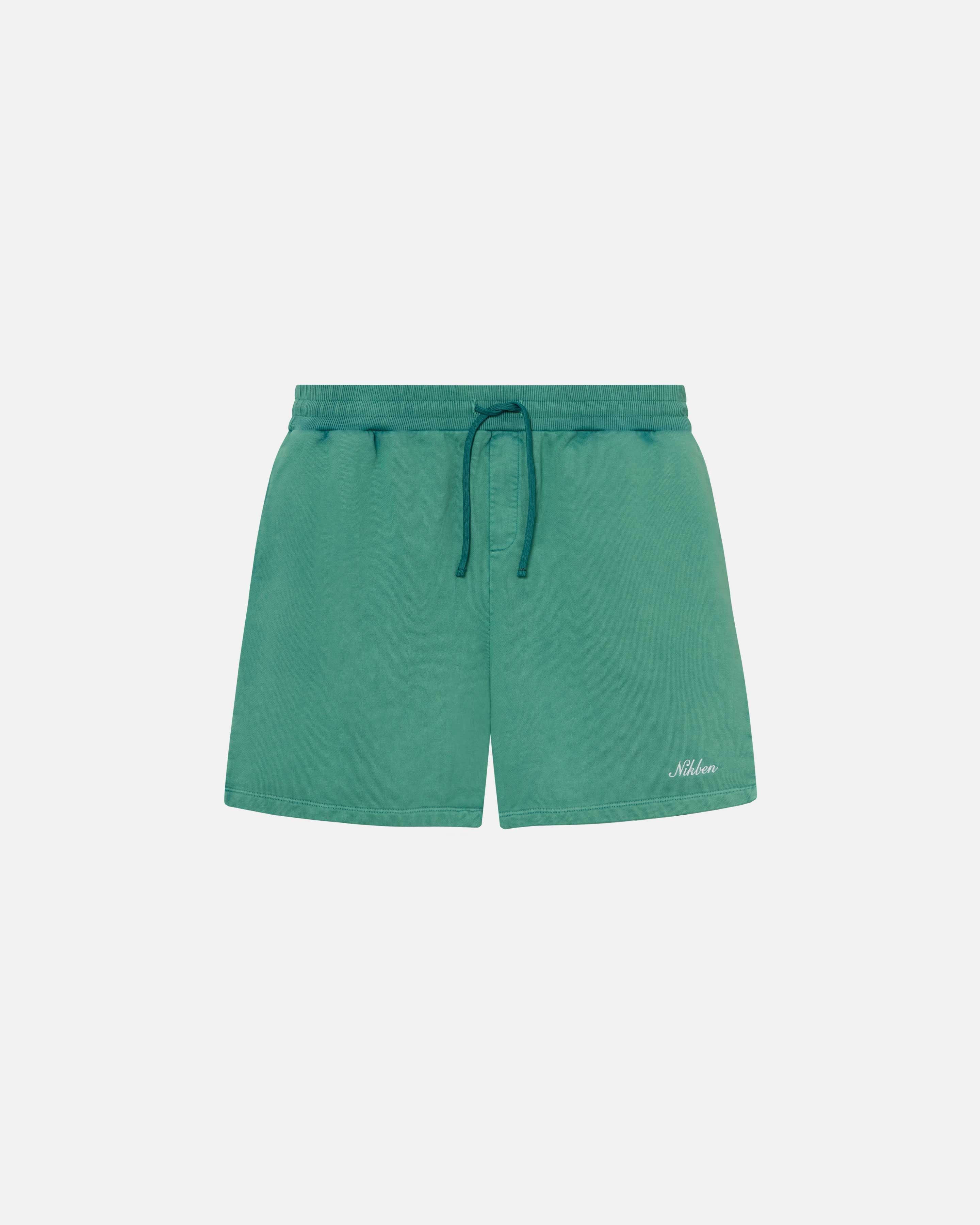 Green sweatshorts with elastic drawstrings and an embroidered script logo on the front leg