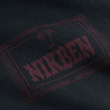 Close up of red chest print on a black garment dyed t-shirt