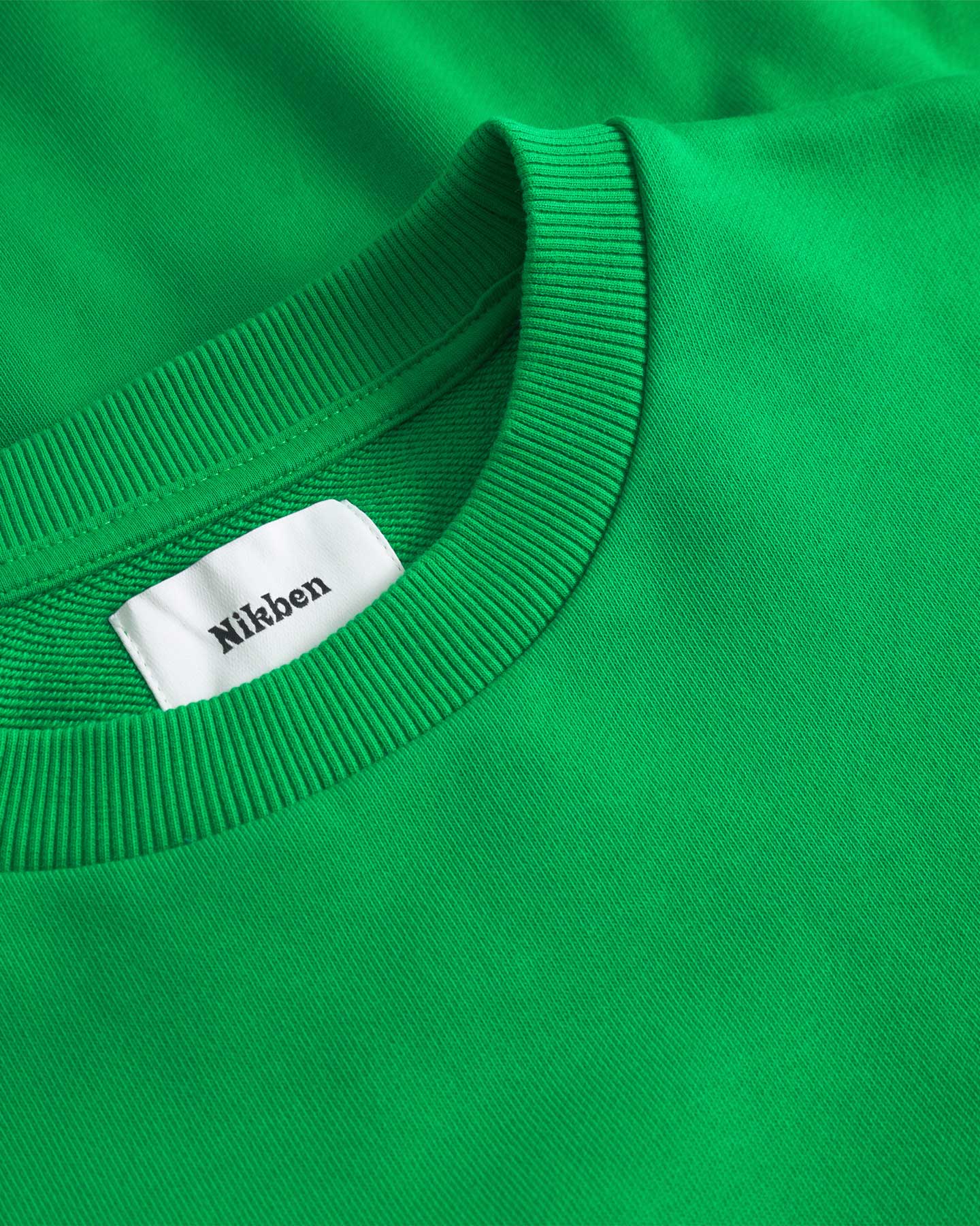 Close up of ribbed collar on a green sweatshirt