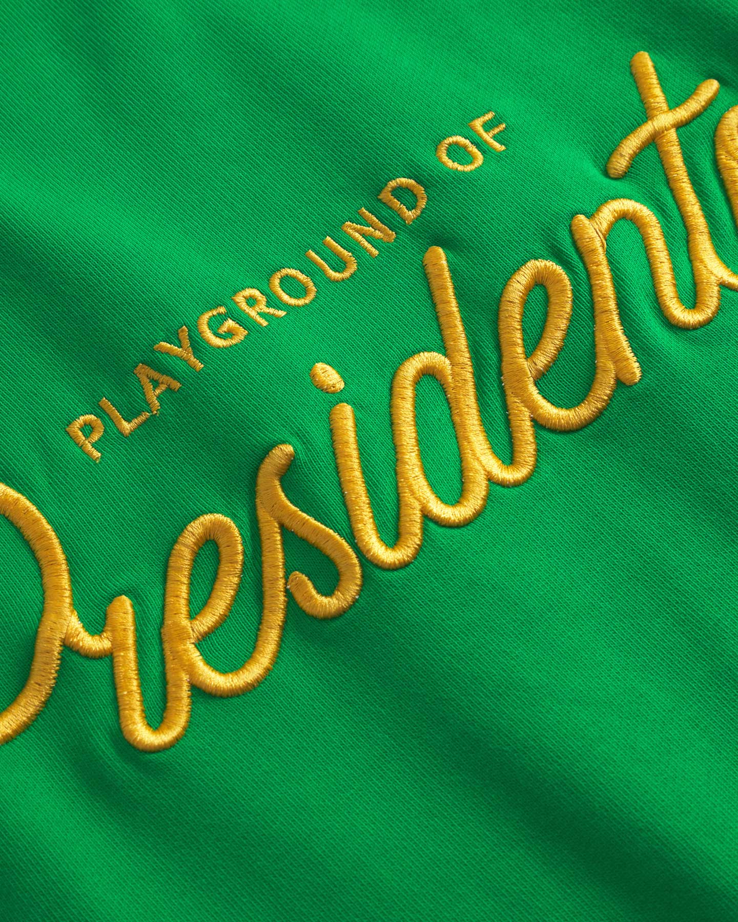 Close up of embroidery on a green sweatshirt