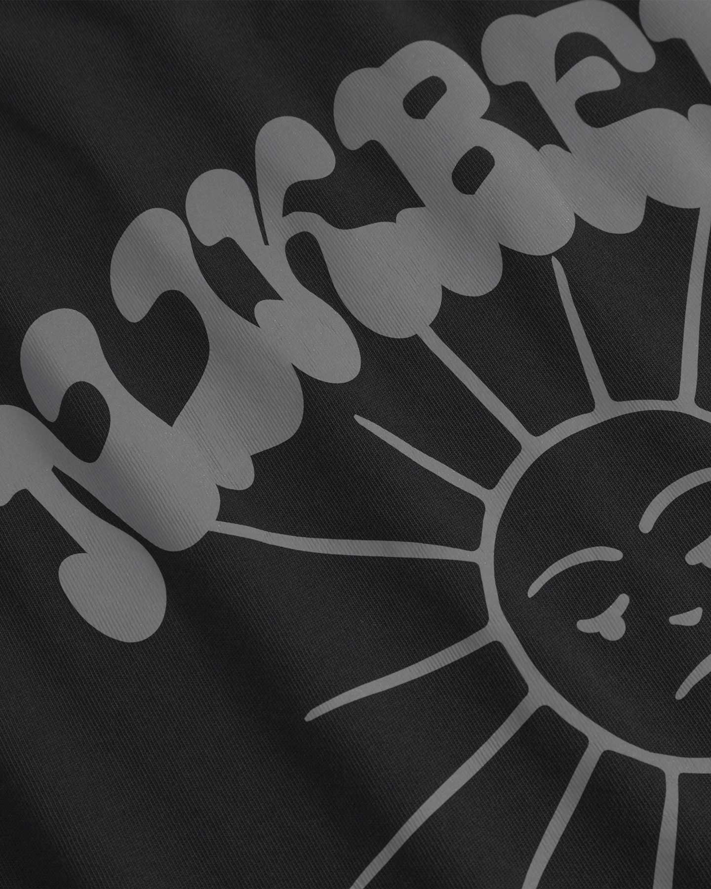 Close up of sunshine print on a black t-shirt