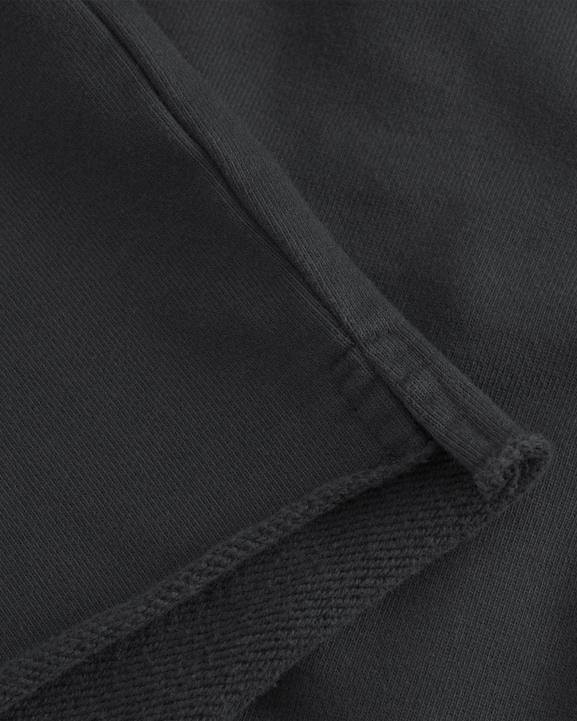 Close up of black cropped hoodie with drawstrings and ribbed cuffs