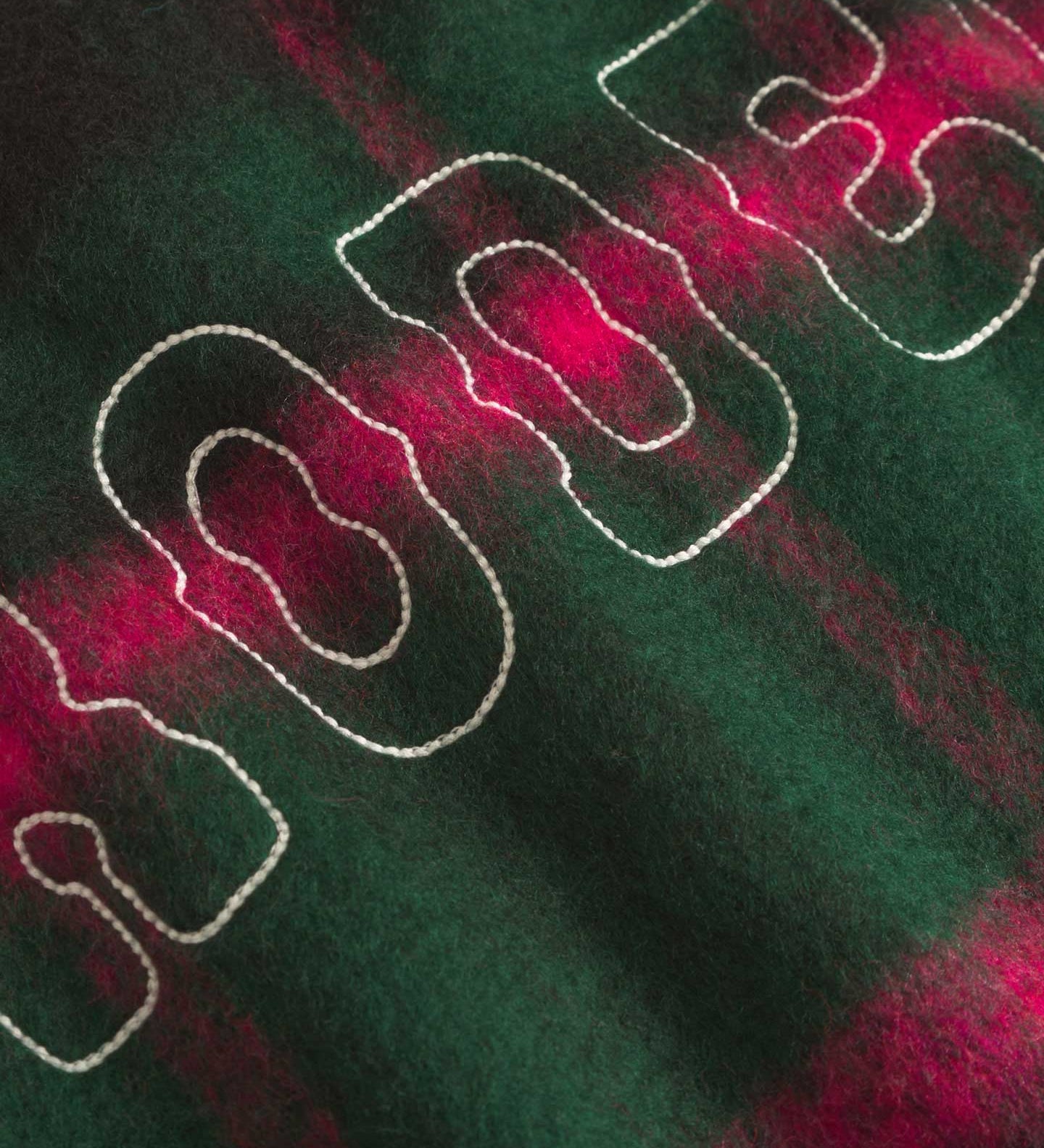 Cloe up of back on a Green and pink colored lumberjack jacket with pockets, full zipper and embroidered Nikben logo 