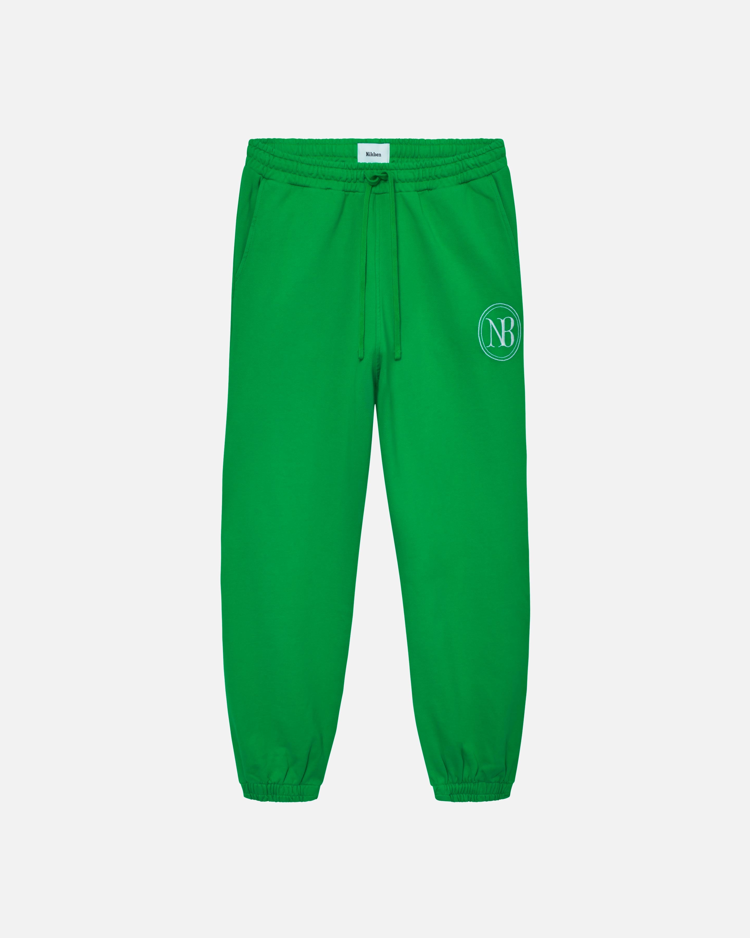 Green sweatpants with drawstrings, ribbed cuffs and embroidered NB logo