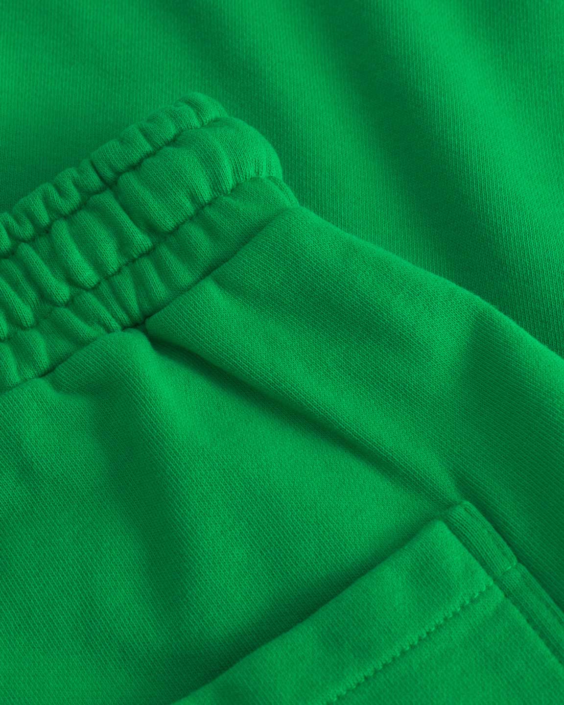 Close up of back pocket on green sweat pants