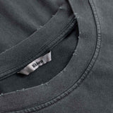 Close-up of black t-shirt with a brand label on the collar.