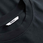 Black t-shirt with a brand label on the collar