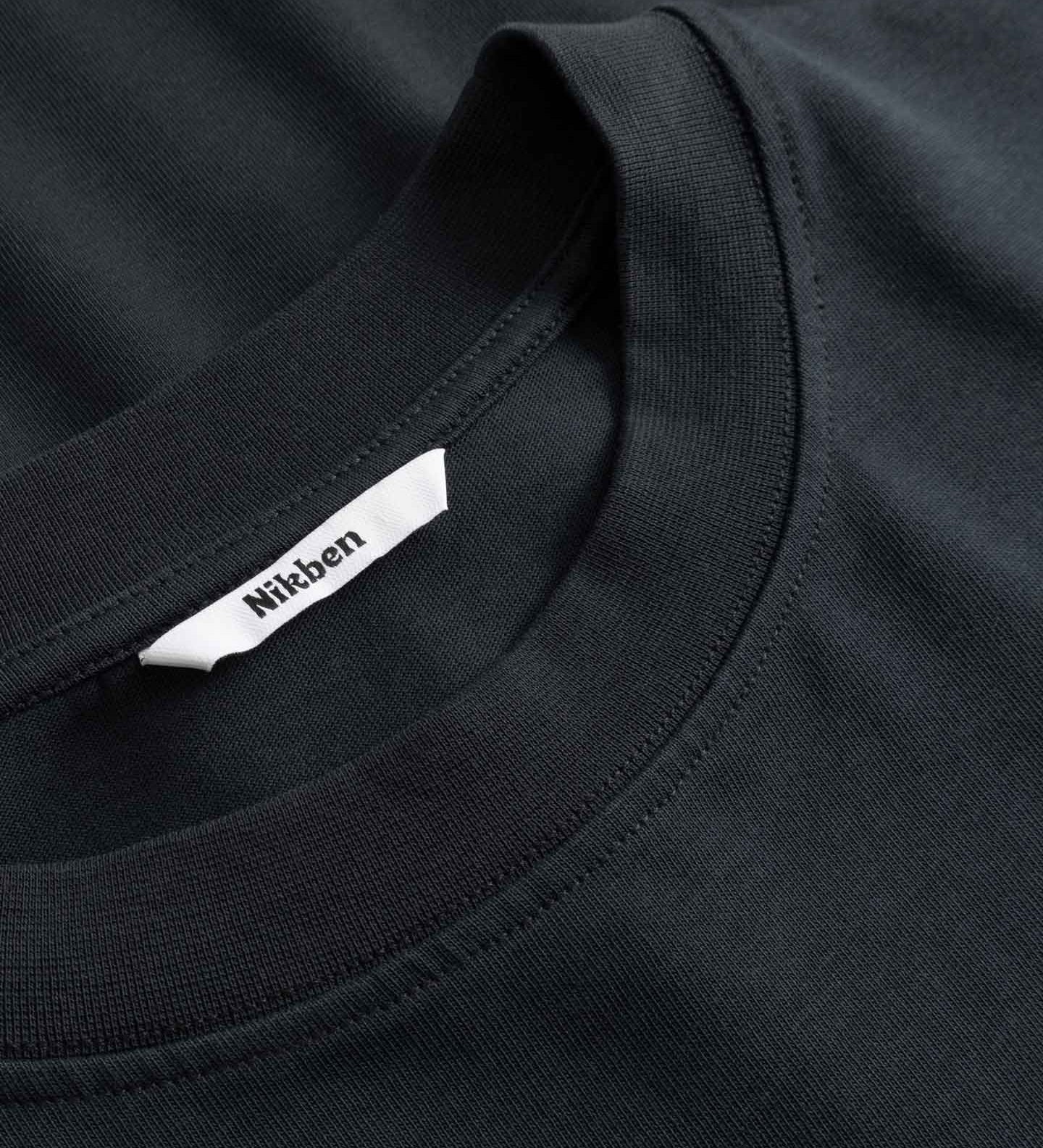 Black t-shirt with a brand label on the collar