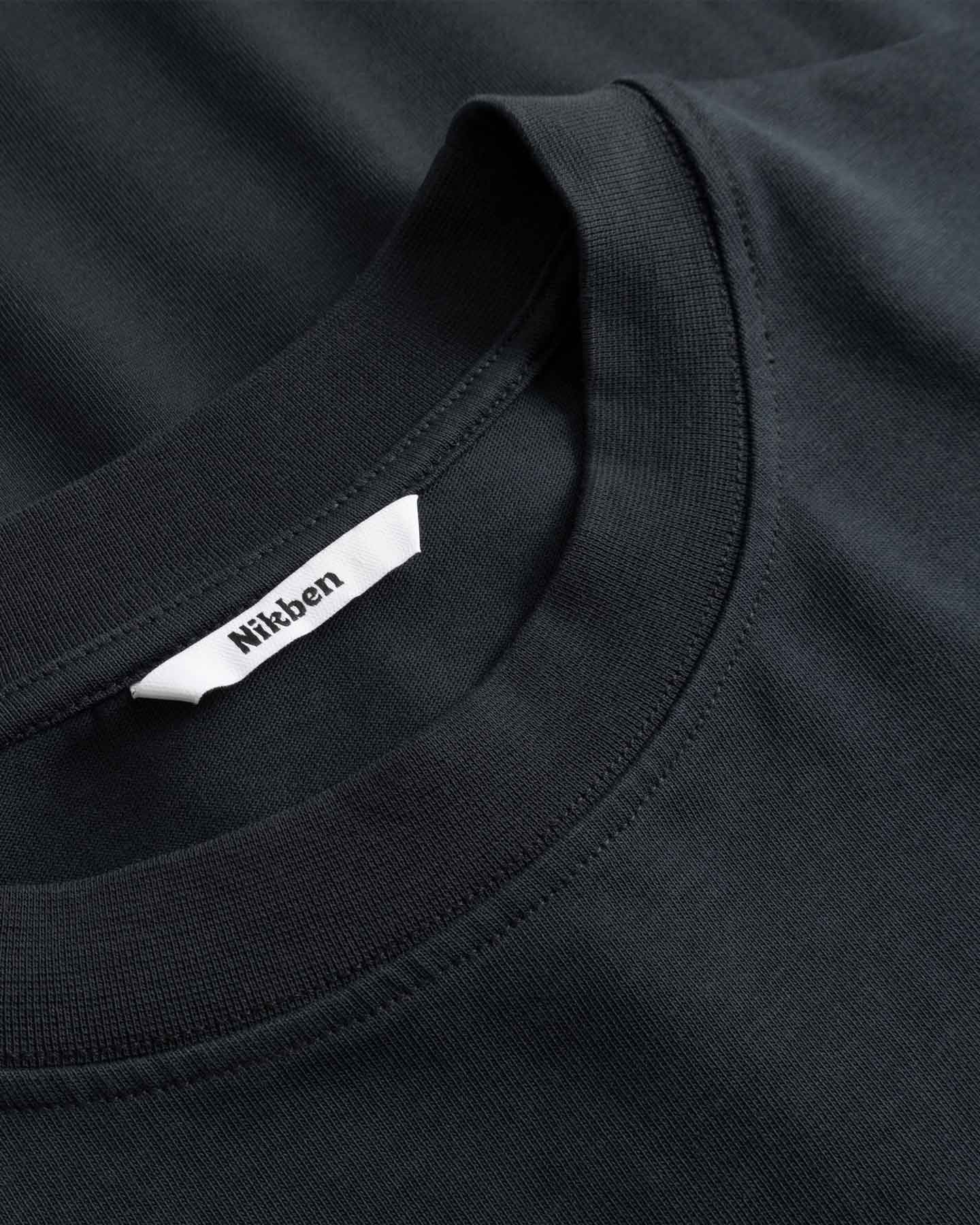 Black t-shirt with a brand label on the collar