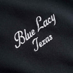 Embroidered white text 'Blue Lacy Texas' on a black background