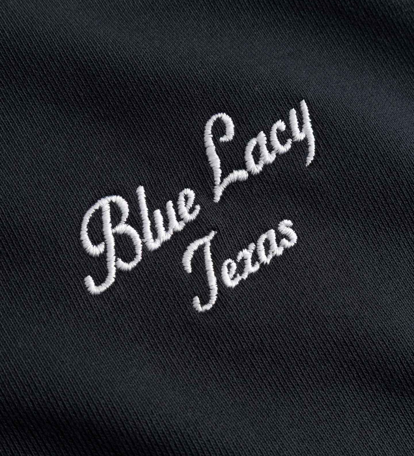 Embroidered white text 'Blue Lacy Texas' on a black background