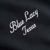 Embroidered white text 'Blue Lacy Texas' on a black background