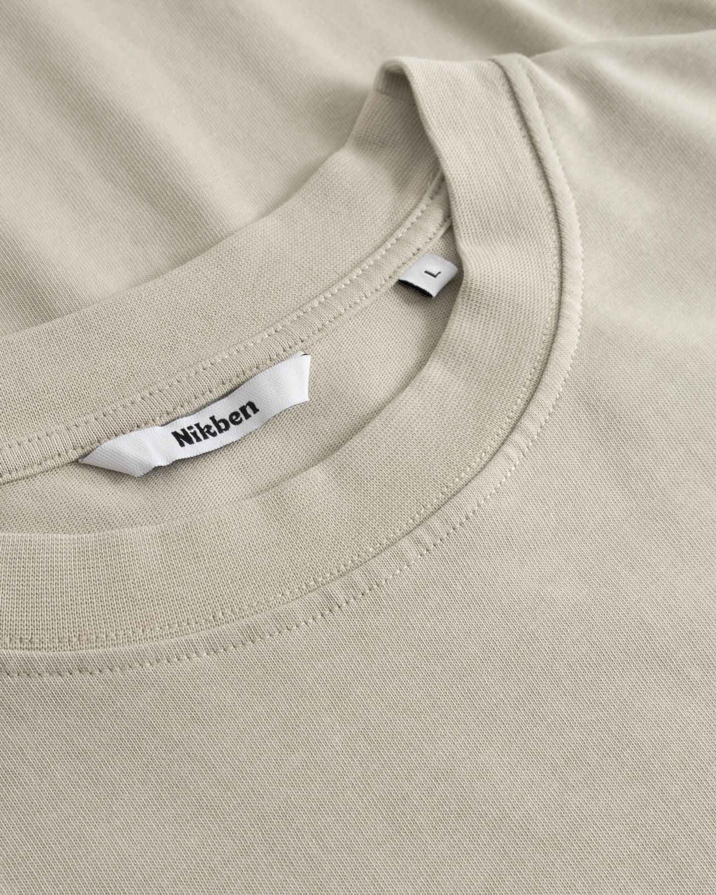 Close up of collar on beige t-shirt
