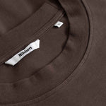 Close-up of a brown T- Shirt with a Nikben label