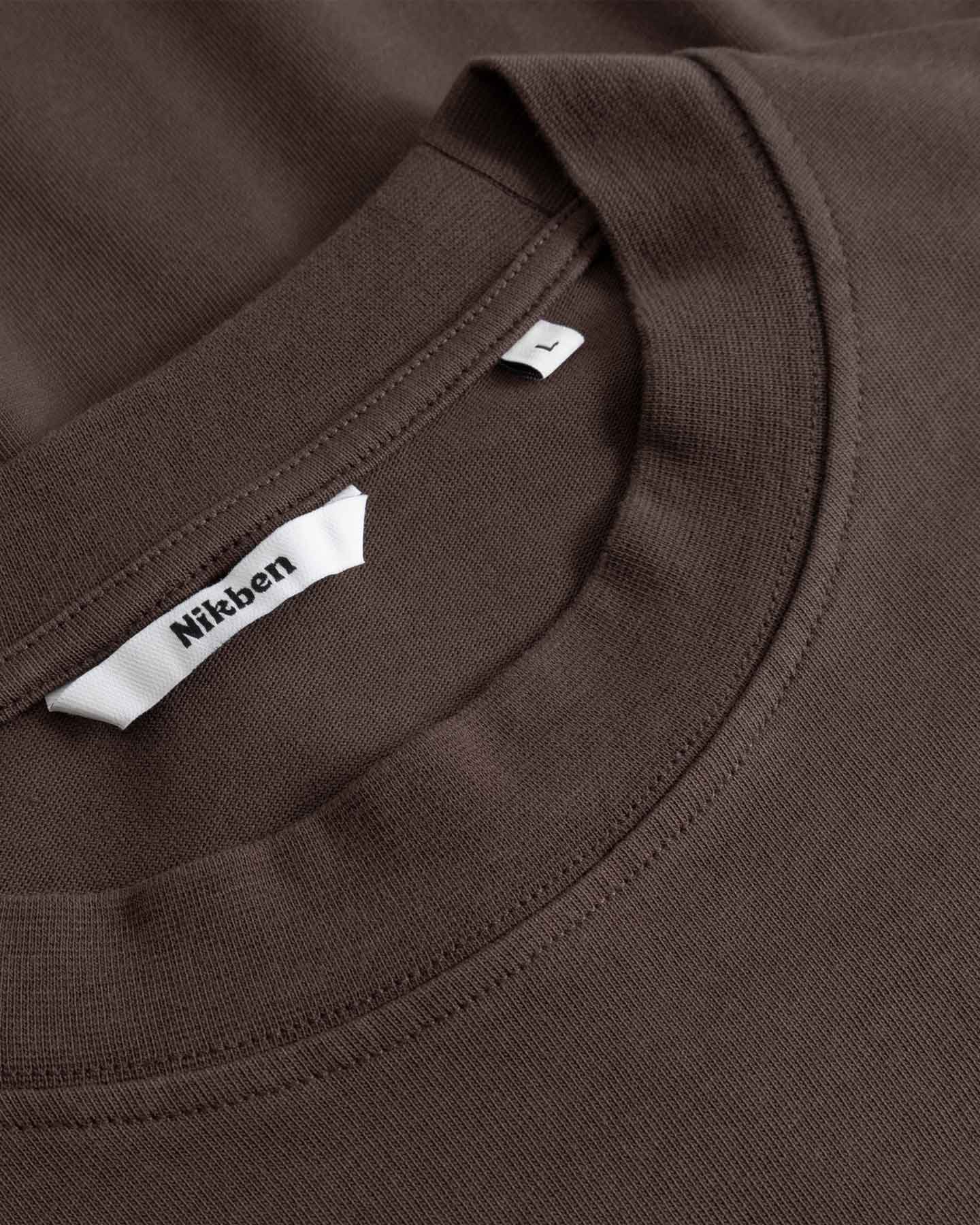 Close-up of a brown T- Shirt with a Nikben label