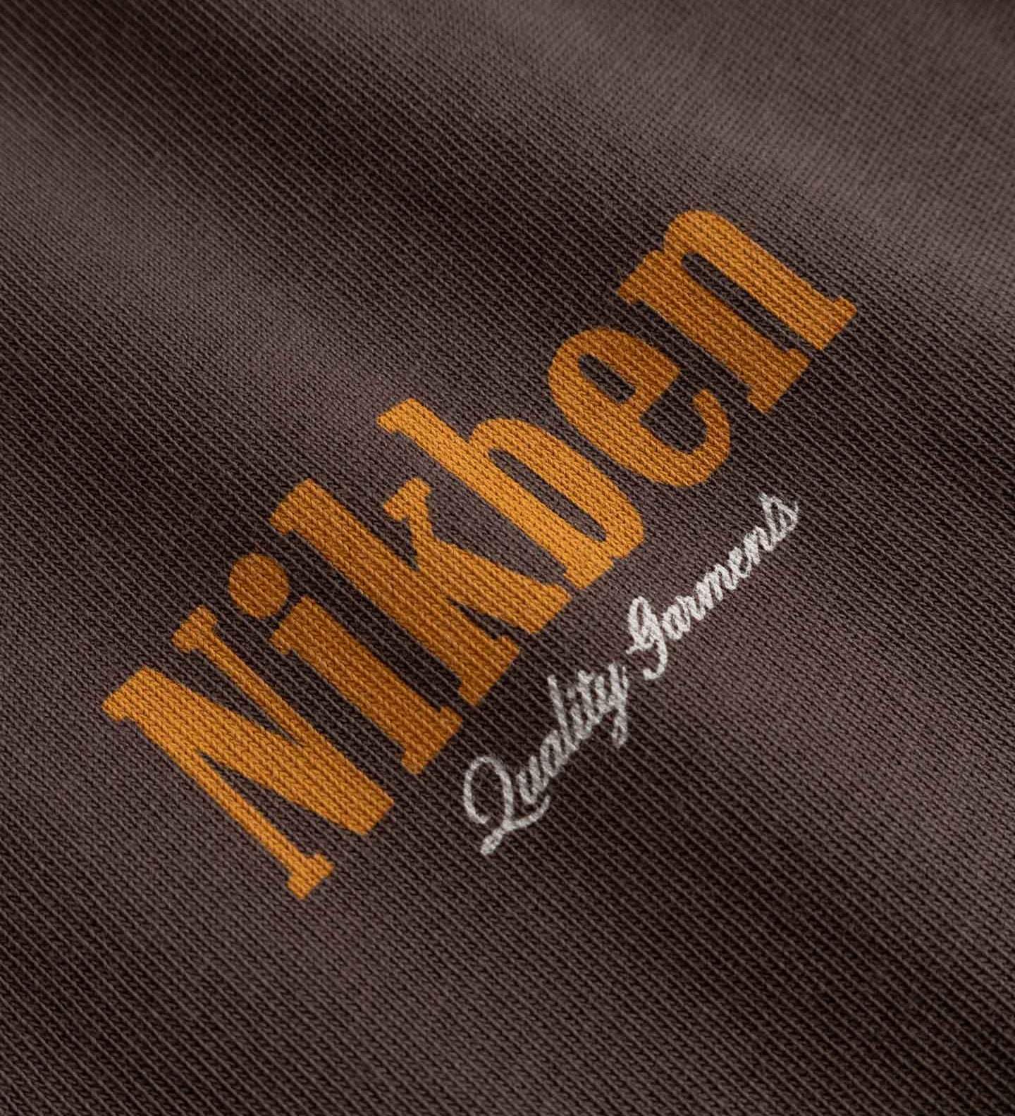 Close-up of 'Nikben' logo on a textured brown fabric 