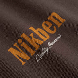 Close-up of 'Nikben' logo on a textured brown fabric 