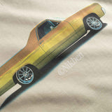Close up of yellow car graphic on a beige fabric