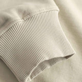 Close-up of beige ribbed sweater sleeve cuff 
