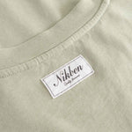 Close-up of  beige fabric with 'Nikben' label.