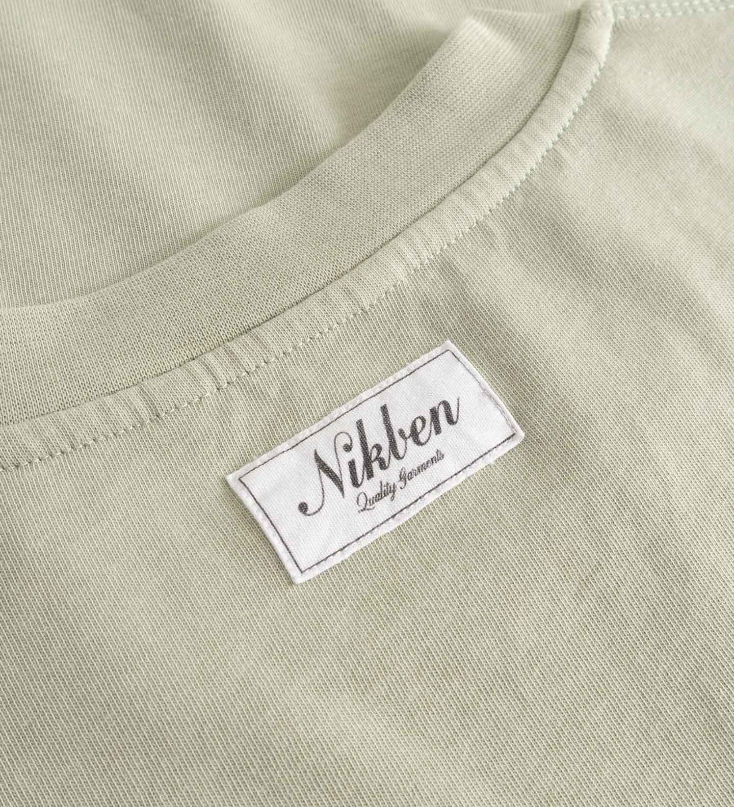 Close-up of  beige fabric with 'Nikben' label.