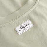 Close-up of  beige fabric with 'Nikben' label.