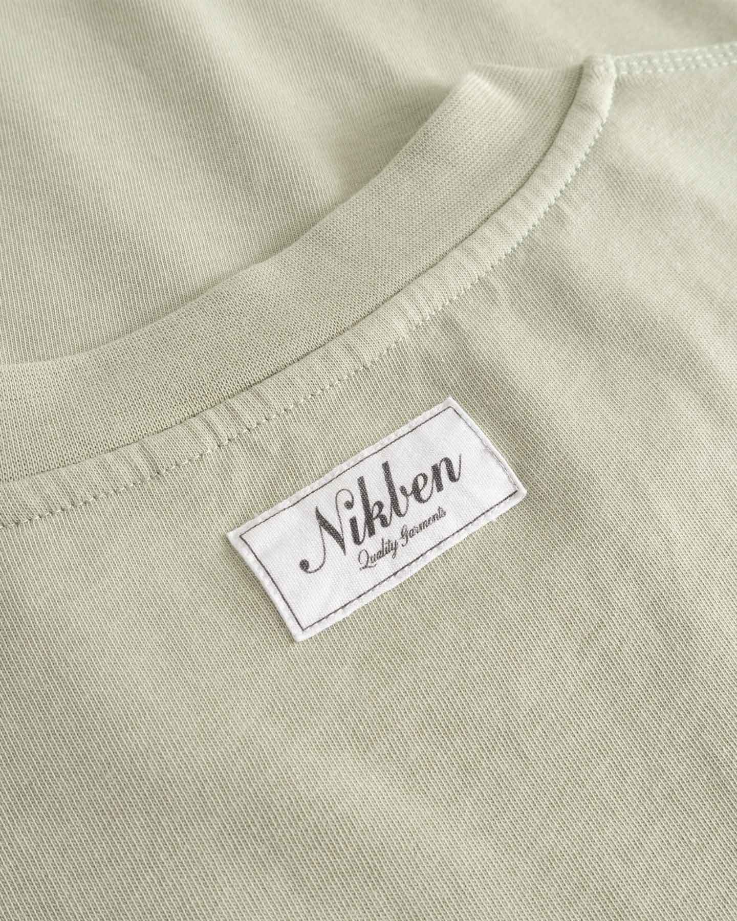 Close-up of  beige fabric with 'Nikben' label.