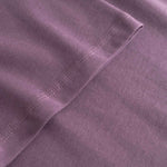 Close-up of a purple fabric with stitching detail