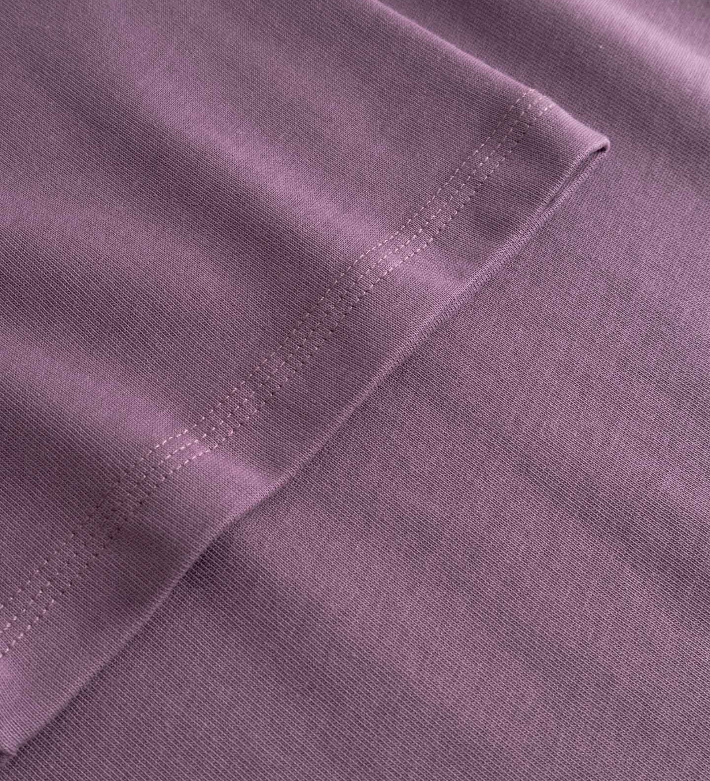 Close-up of a purple fabric with stitching detail