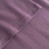 Close-up of a purple fabric with stitching detail