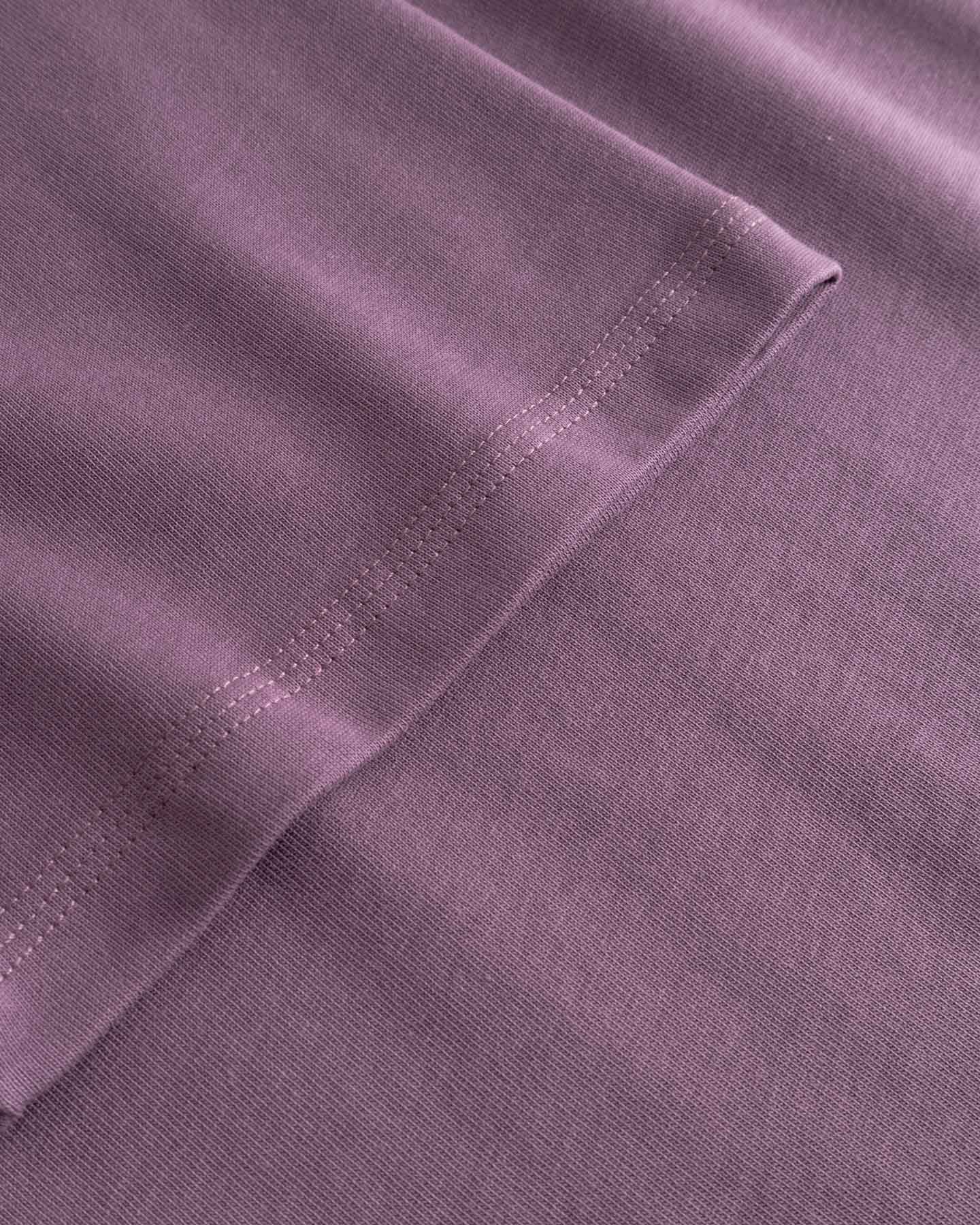 Close-up of a purple fabric with stitching detail