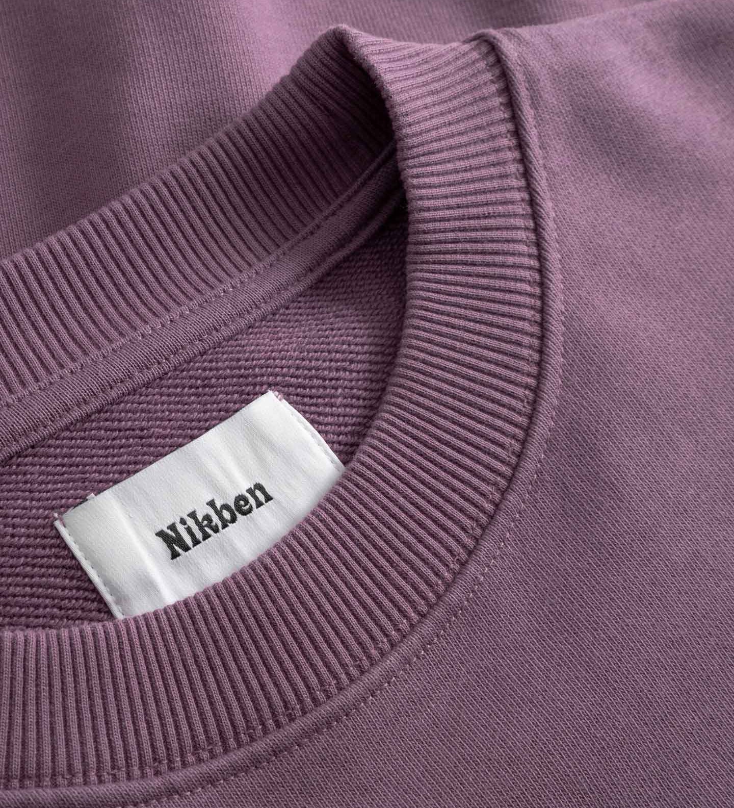 Close-up of purple sweatshirt with visible 'Nikben' label.