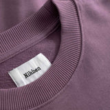Close-up of purple sweatshirt with visible 'Nikben' label.