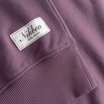 Close-up of sleeve cuff with 'Nikben' label stitched on. 