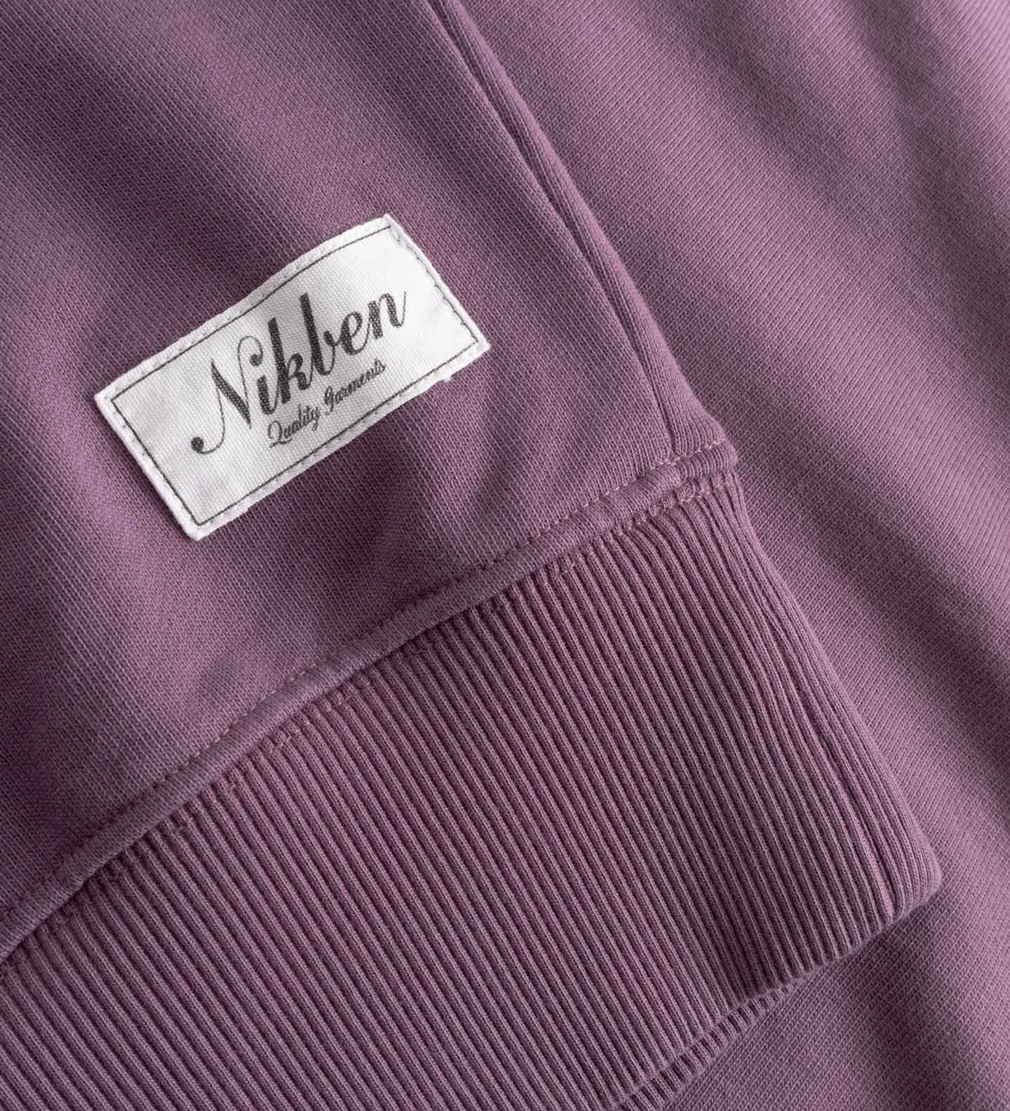 Close-up of sleeve cuff with 'Nikben' label stitched on. 