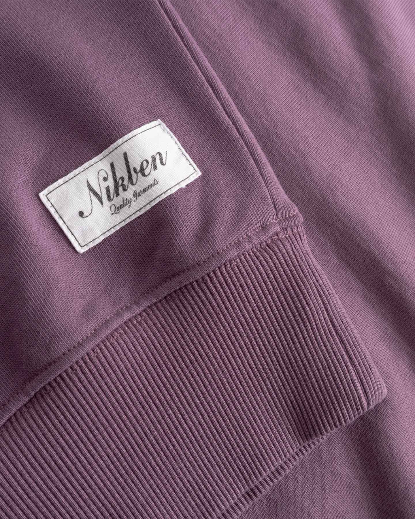 Close-up of sleeve cuff with 'Nikben' label stitched on. 