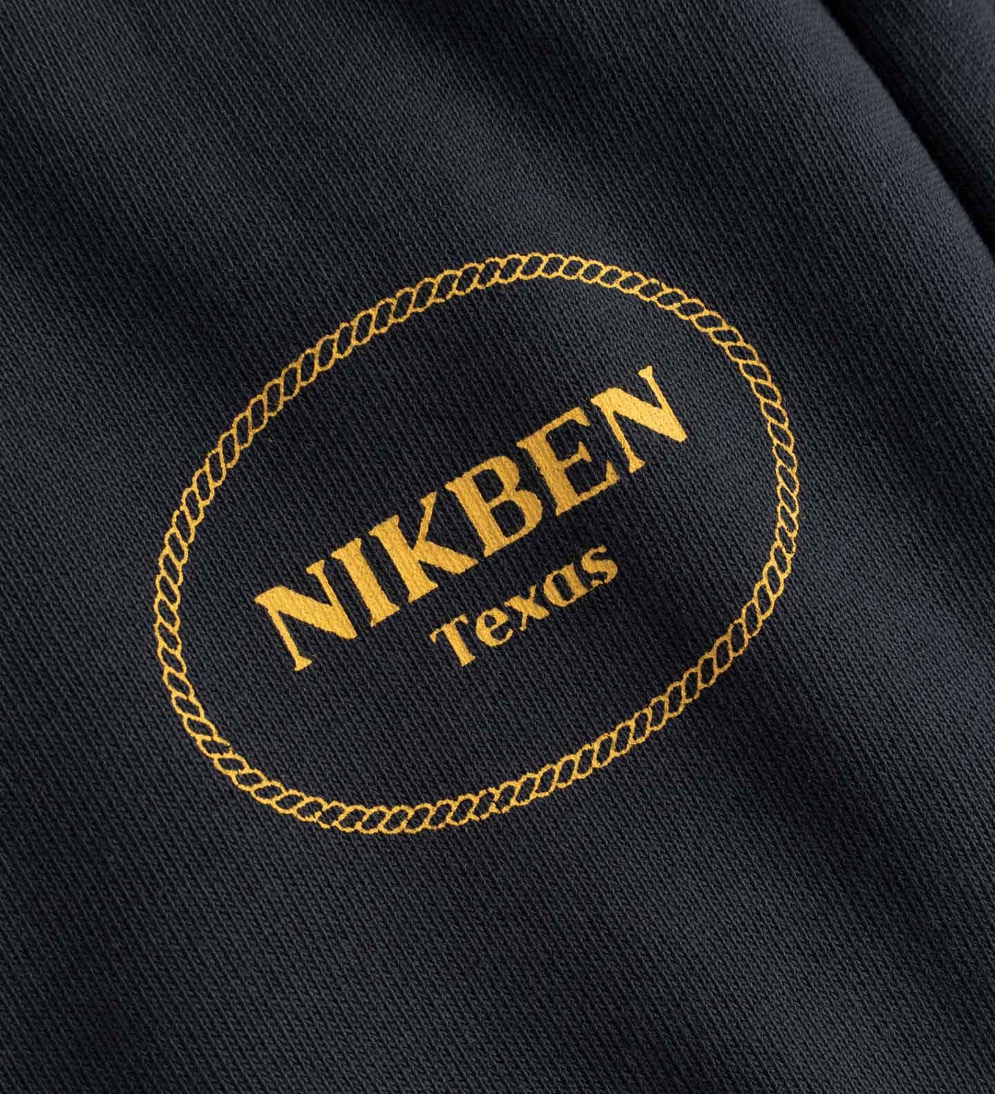 Nikben Texas logo on a black fabric background