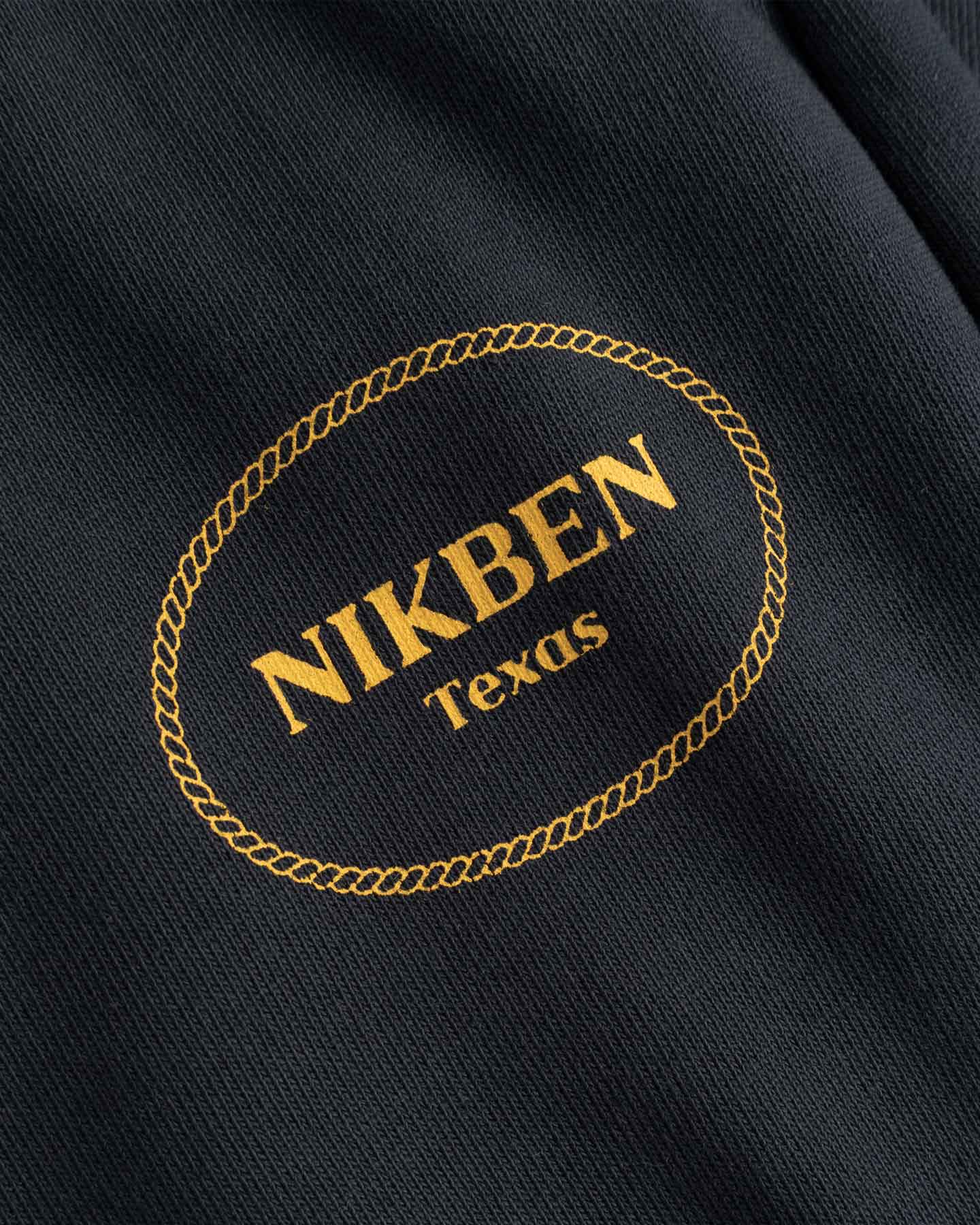 Nikben Texas logo on a black fabric background