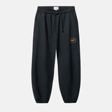 Black jogger pants with a small logo on leg