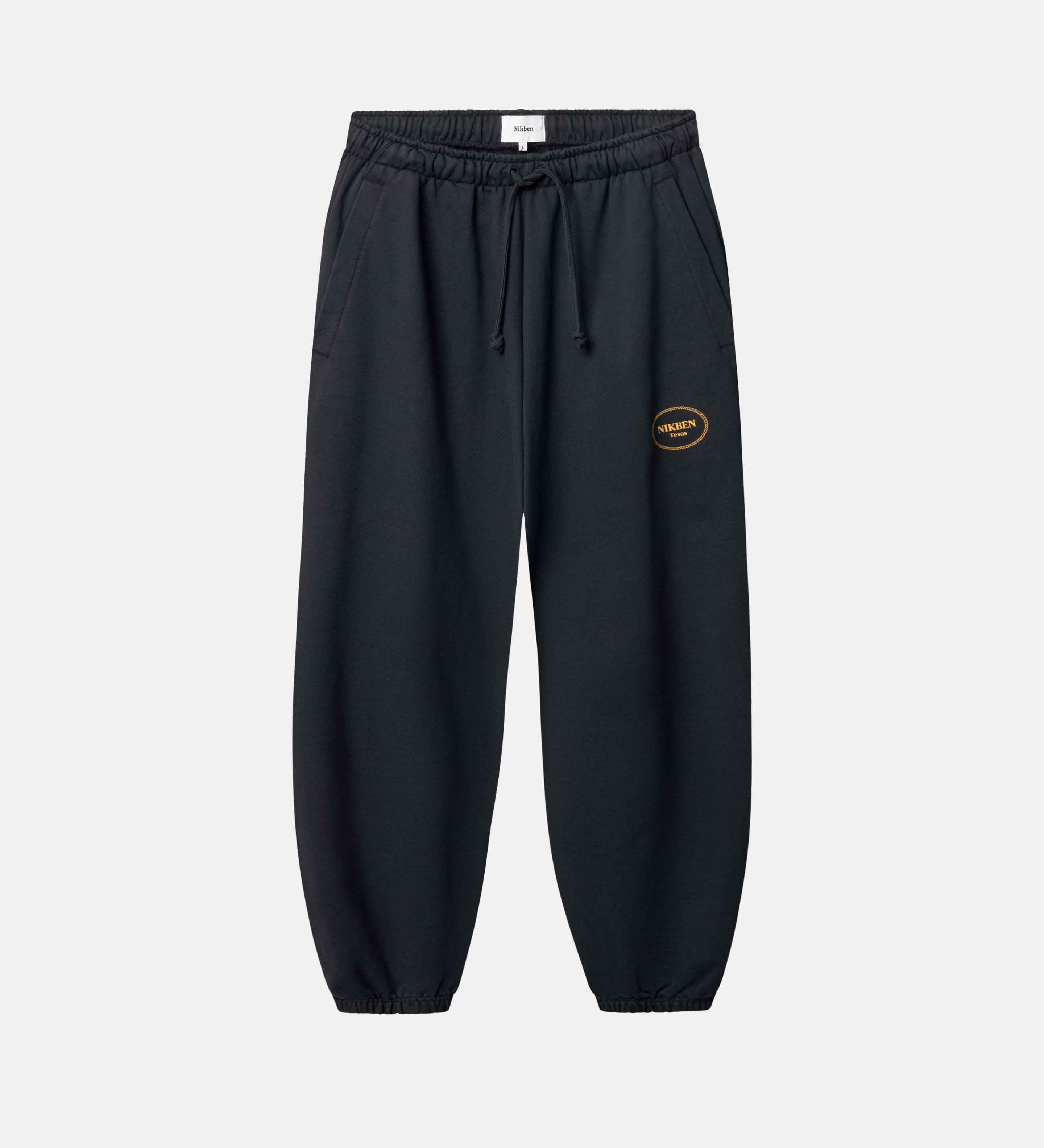 Black jogger pants with a small logo on leg