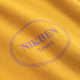 Close-up of a yellow fabric with 'NIKBEN Texas' printed on it.