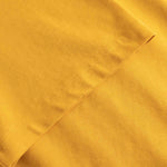 Close-up of yellow fabric with a subtle pattern