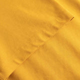 Close-up of yellow fabric with a subtle pattern
