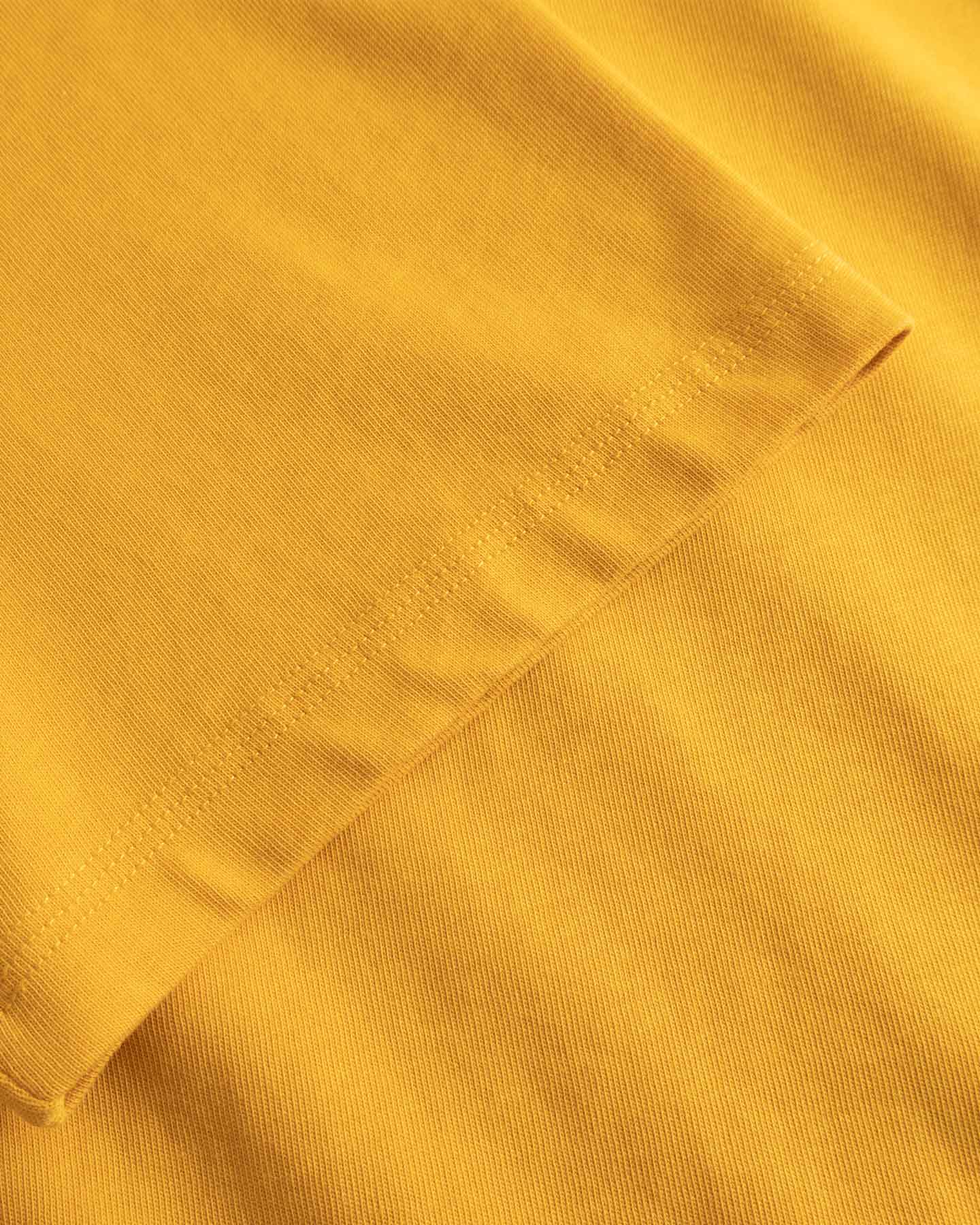 Close-up of yellow fabric with a subtle pattern