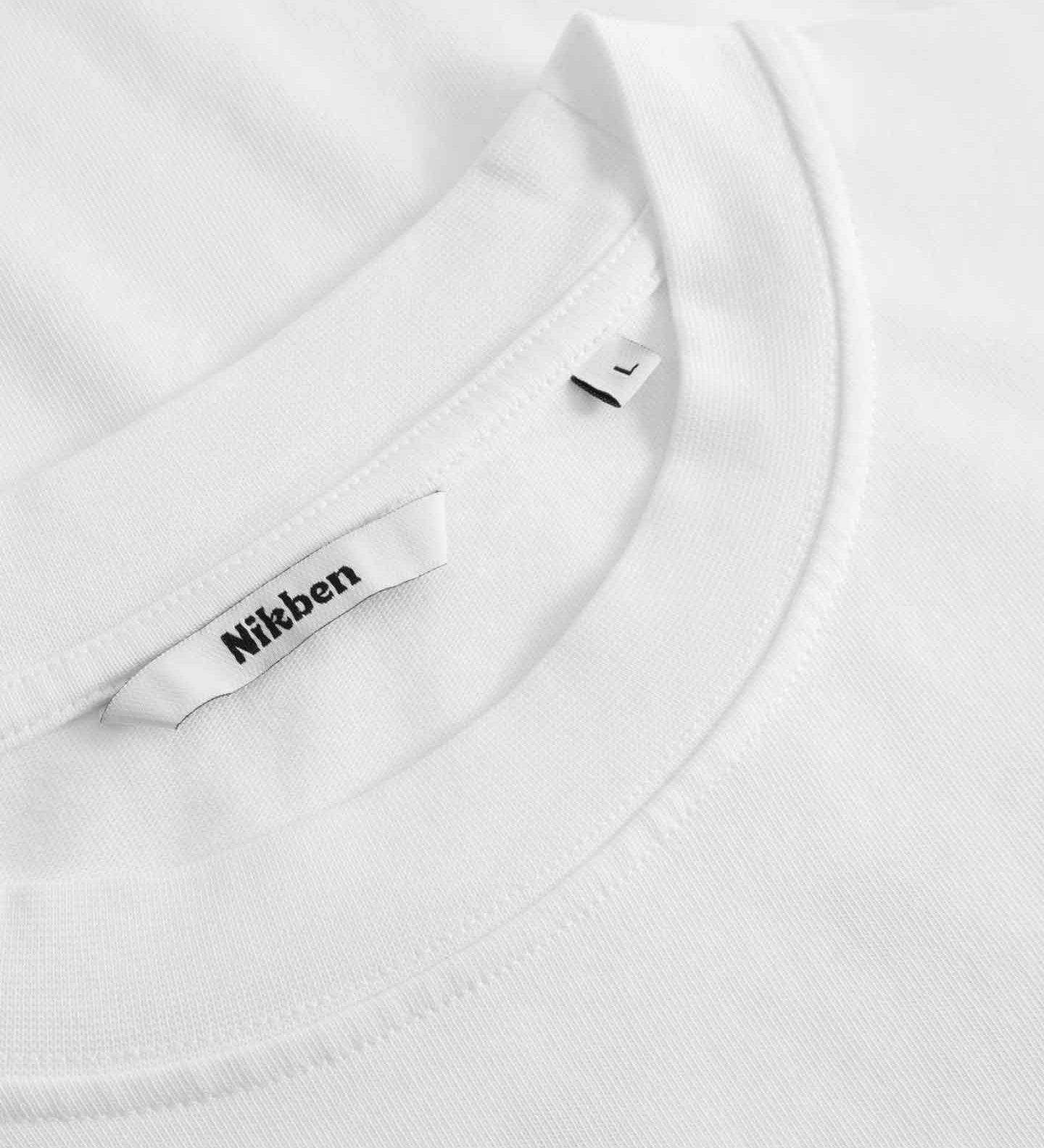 Close-up of a white t shirt with a brand label on a white tshirt