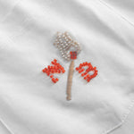 Close up of embroidered logo on front breast pocket