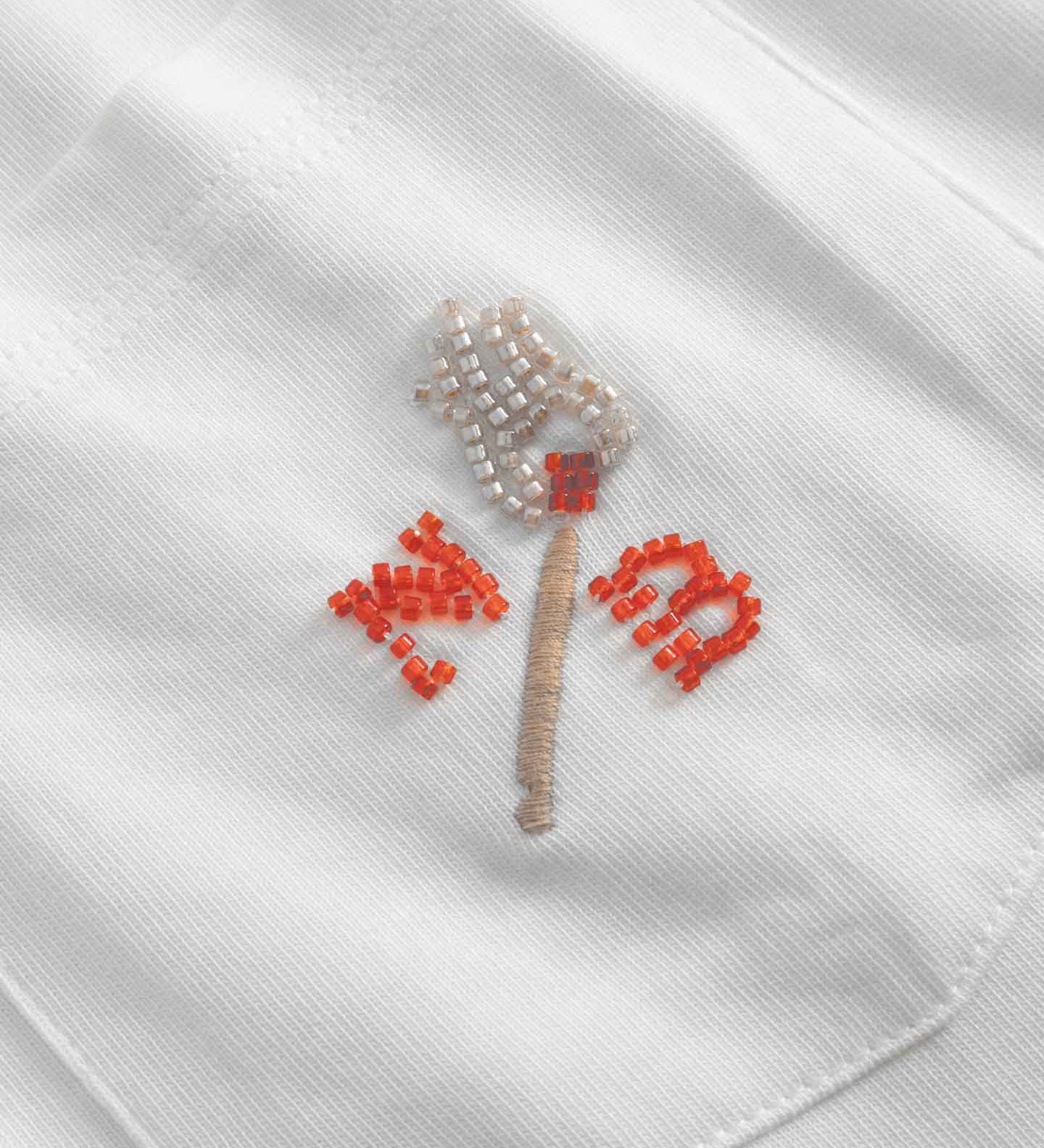 Close up of embroidered logo on front breast pocket