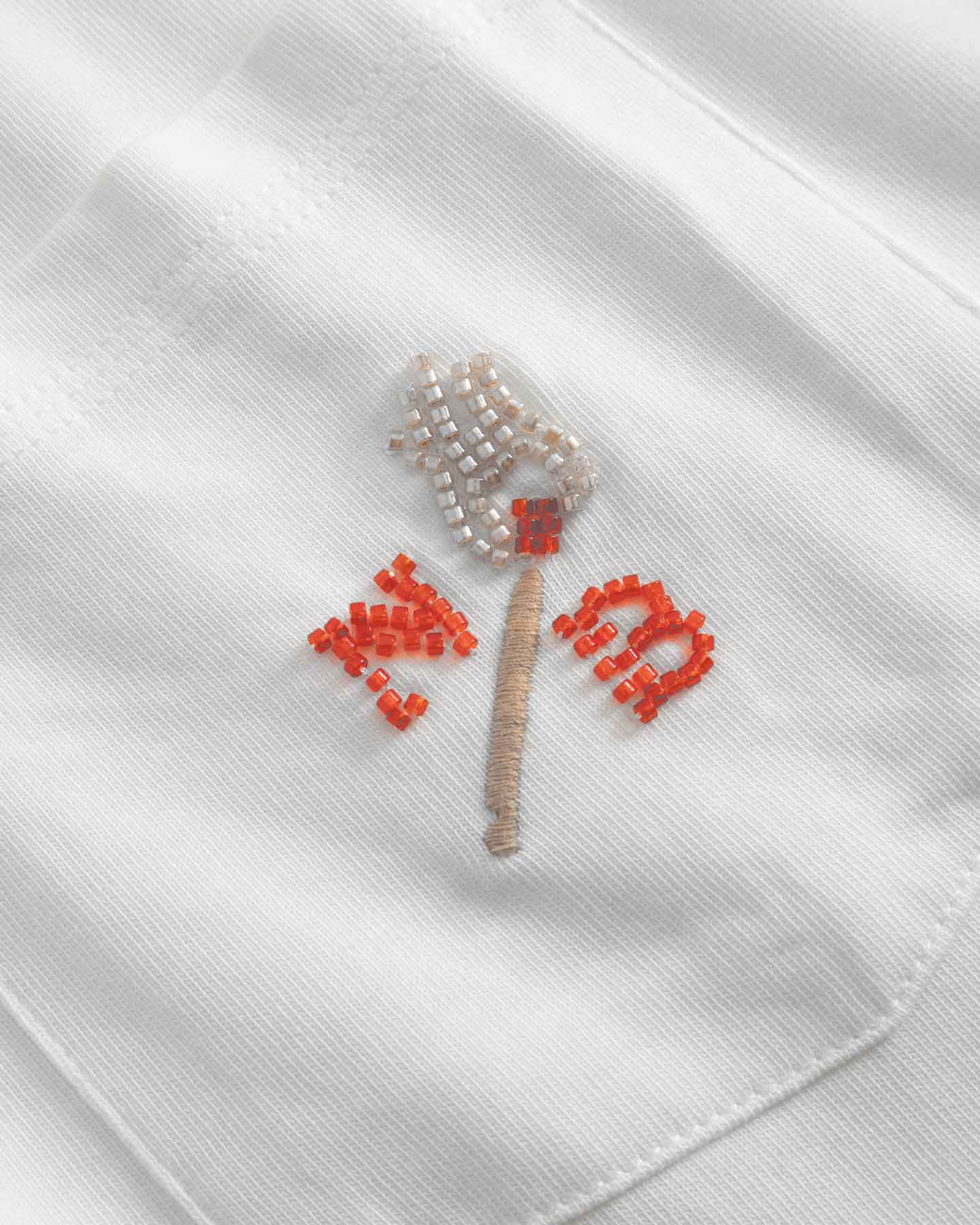 Close up of embroidered logo on front breast pocket