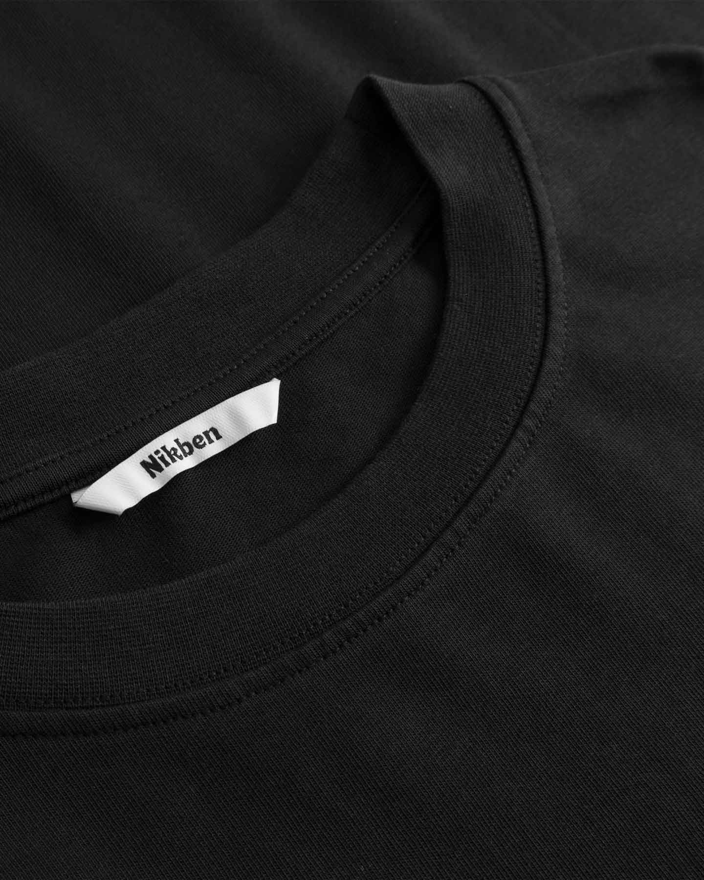 Black t-shirt with a Nikken label on the collar